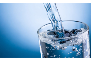 Clean water poured from a pitcher after undergoing treatment from a water system.